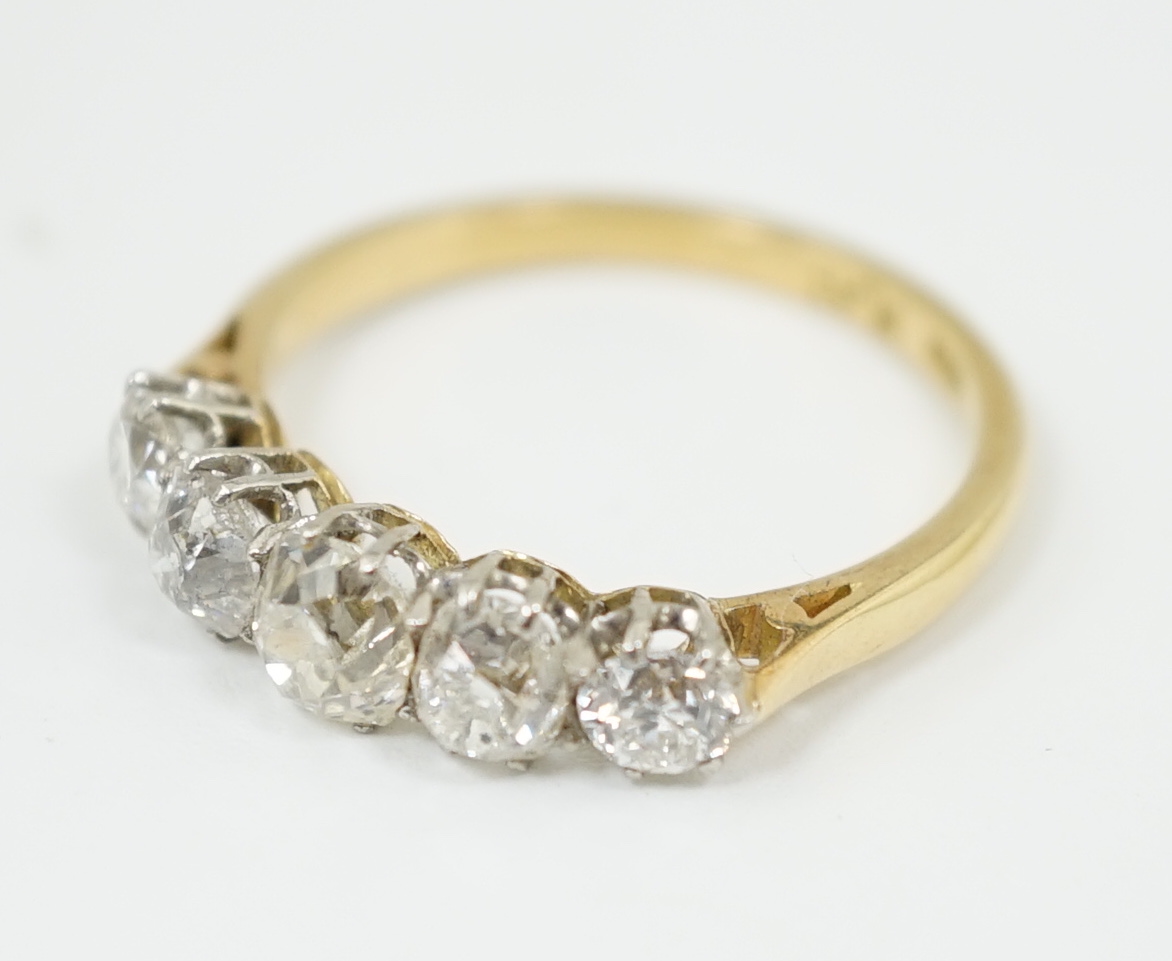 An early to mid 20th century 18ct gold, platinum and graduated five diamond set half hoop ring